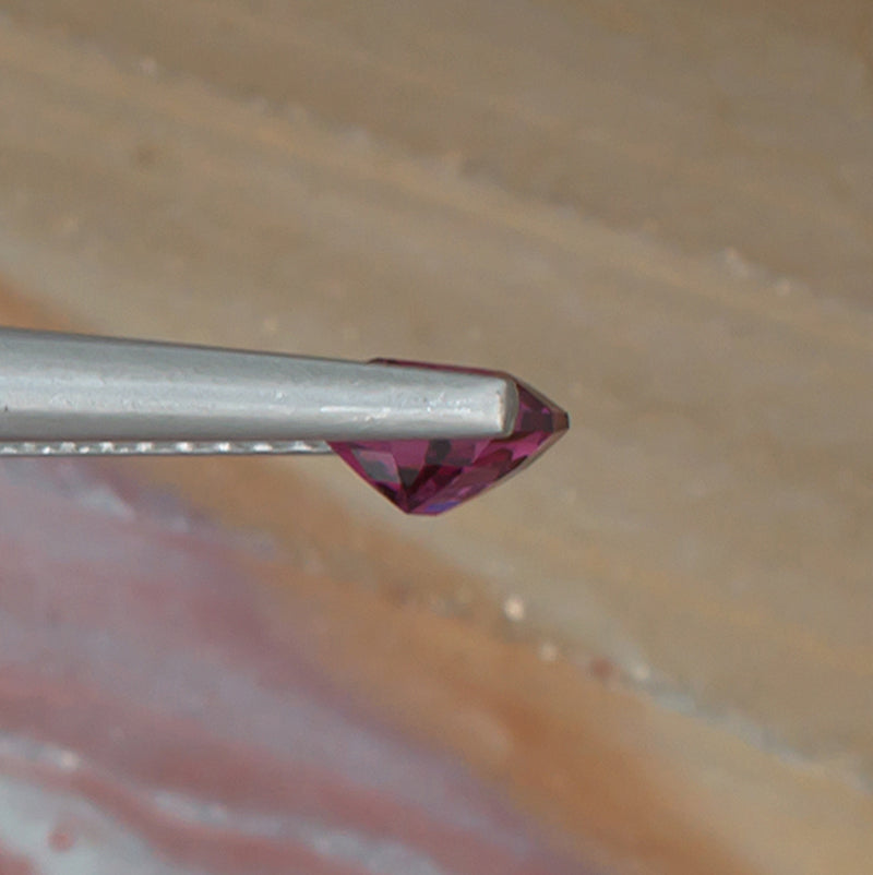 0.88ct Rhodolite Garnet Colored Gemstone Side View Natural Background 