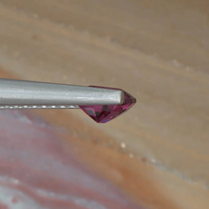 0.88ct Rhodolite Garnet Colored Gemstone Side View Natural Background 