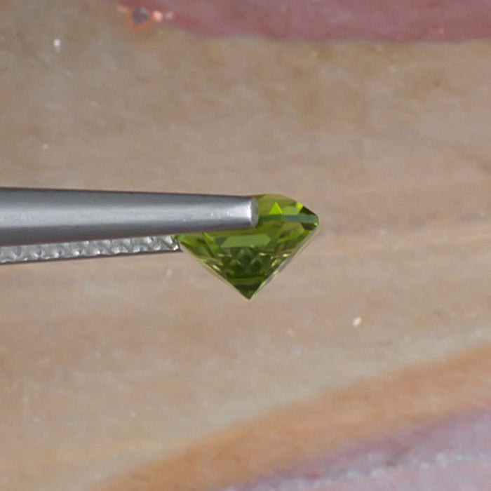 1.10ct Peridot Colored Gemstone Side View Natural Background 
