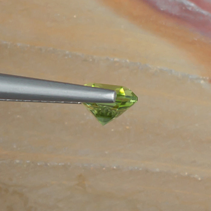 1.10ct Peridot Colored Gemstone Side View Natural Background 
