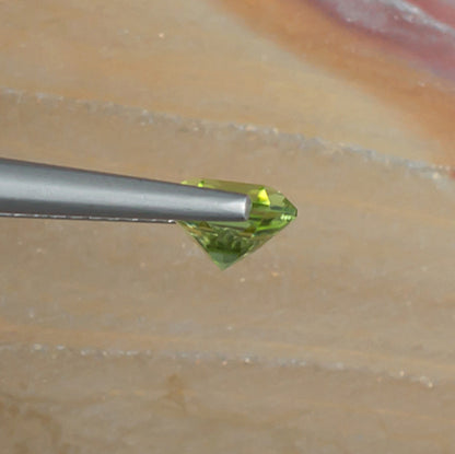 1.10ct Peridot Colored Gemstone Side View Natural Background 
