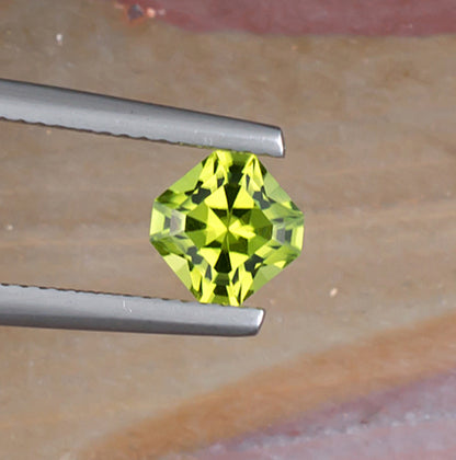 1.10ct Peridot Colored Gemstone Top View Angle Natural Background
