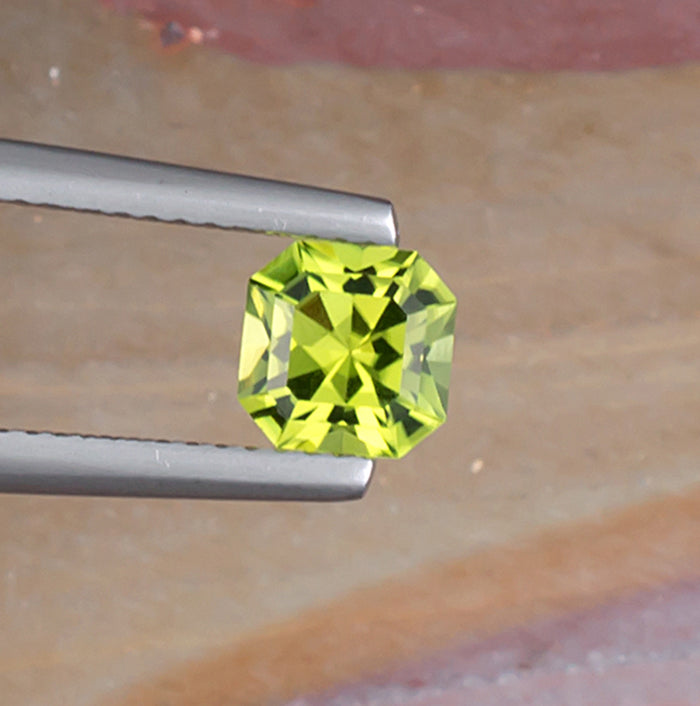 1.10ct Peridot Colored Gemstone Top View Natural Background 
