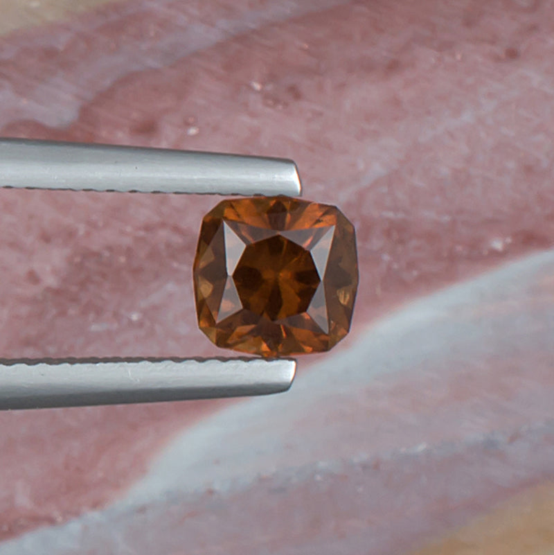 1.18ct Malaya Garnet Colored Gemstone Top View Natural Background 
