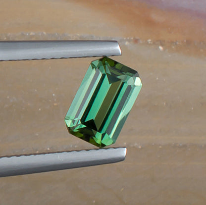 1.24ct Green Tourmaline Colored Gemstone Top View Natural Background 
