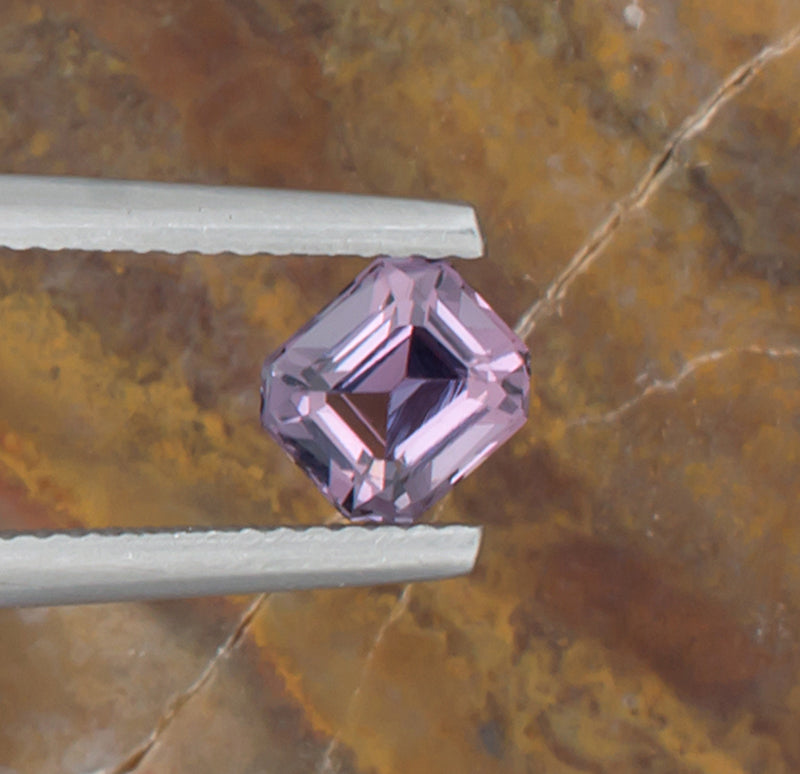 1.24ct Lavender Spinel Colored Gemstone Top View Angle Natural Background 
