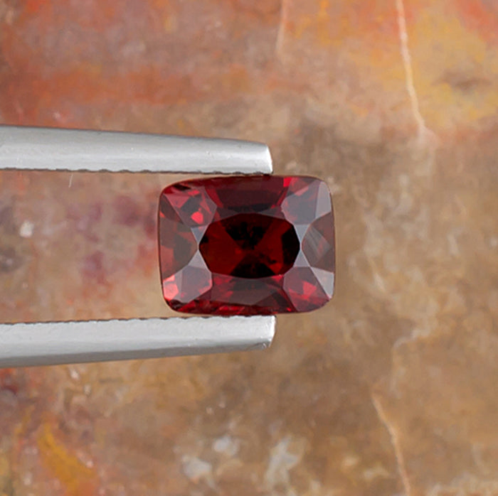 1.50ct Red Spinel Colored Gemstone Top View Natural Background 
