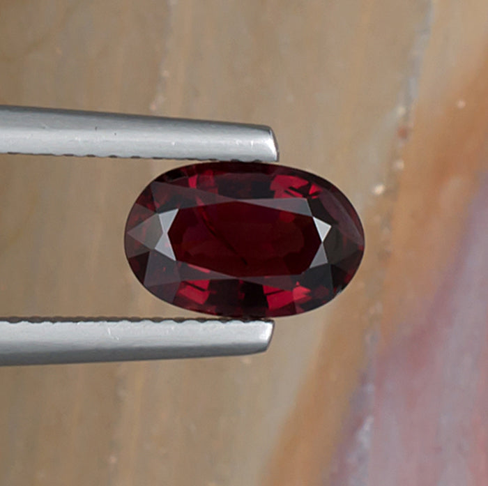 1.70ct Red Spinel Colored Gemstone Top View Natural Background 
