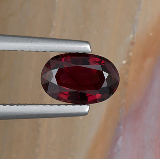 1.70ct Red Spinel Colored Gemstone Top View Natural Background 
