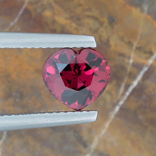 1.96ct Rhodolite Garnet Colored Gemstone Top View Natural Background