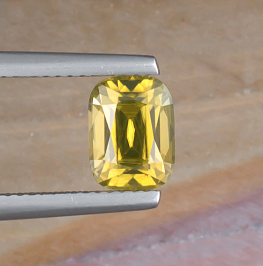 2.45ct Yellow Zircon Colored Gemstone Top View Natural Background 
