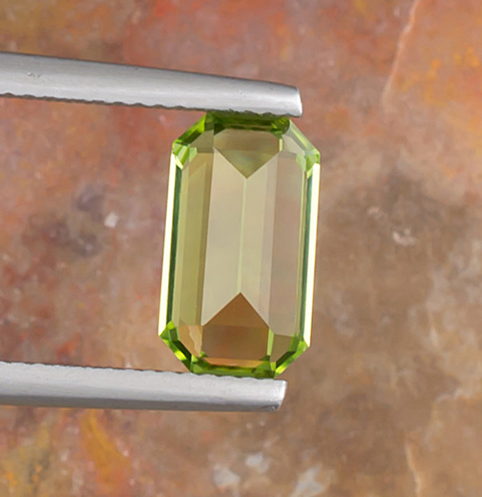 3.17ct Peridot Colored Gemstone Bottom View Natural Background 
