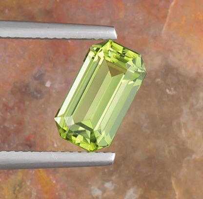 3.17ct Peridot Colored Gemstone Top View Angle Natural Background 
