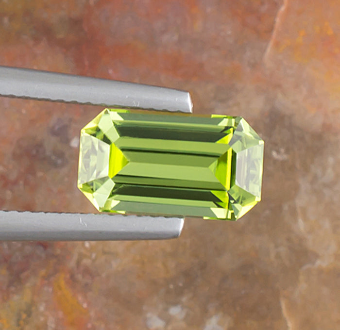 3.17ct Peridot Colored Gemstone Top View Natural Background 
