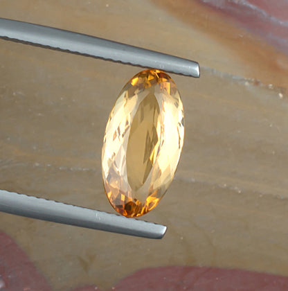 3.35ct Imperial Topaz Colored Gemstone Top View Angle Natural Background 
