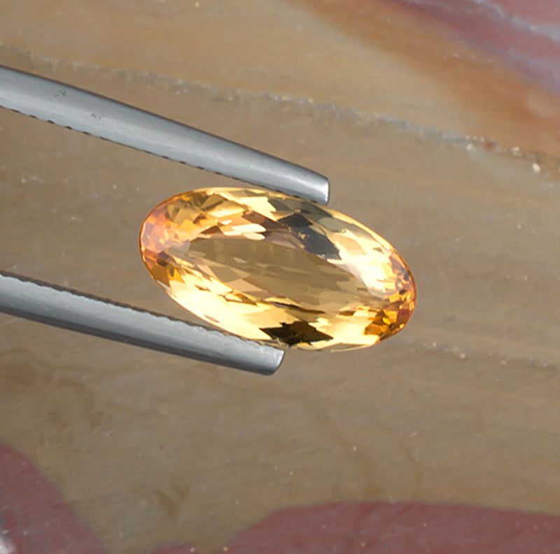 3.35ct Imperial Topaz Colored Gemstone Top View Natural Background 
