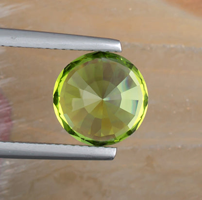 4.80ct Peridot Colored Gemstone Top View Natural Background 
