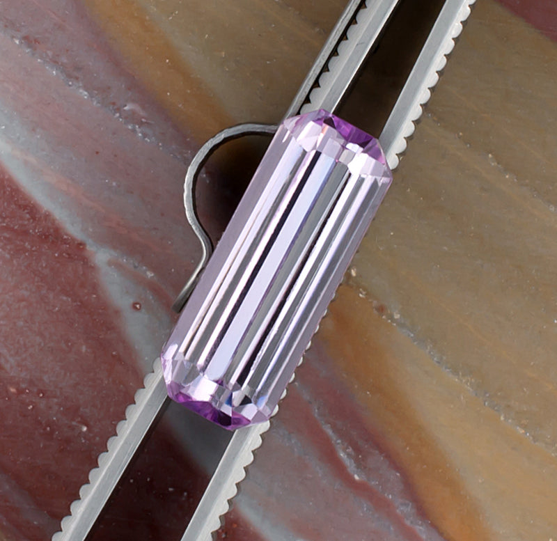 5.58ct Kunzite Colored Gemstone Top View Tweezers Natural Background 
